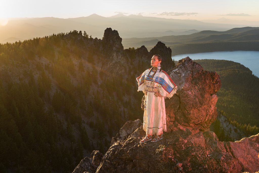 Native woman Acosia M. Red Elk in historic buckskin dress on top of Paulina Peak, Central Oregon, USA